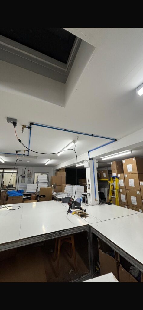Compressed air pipework installed along a workshop wall feeding production machinery